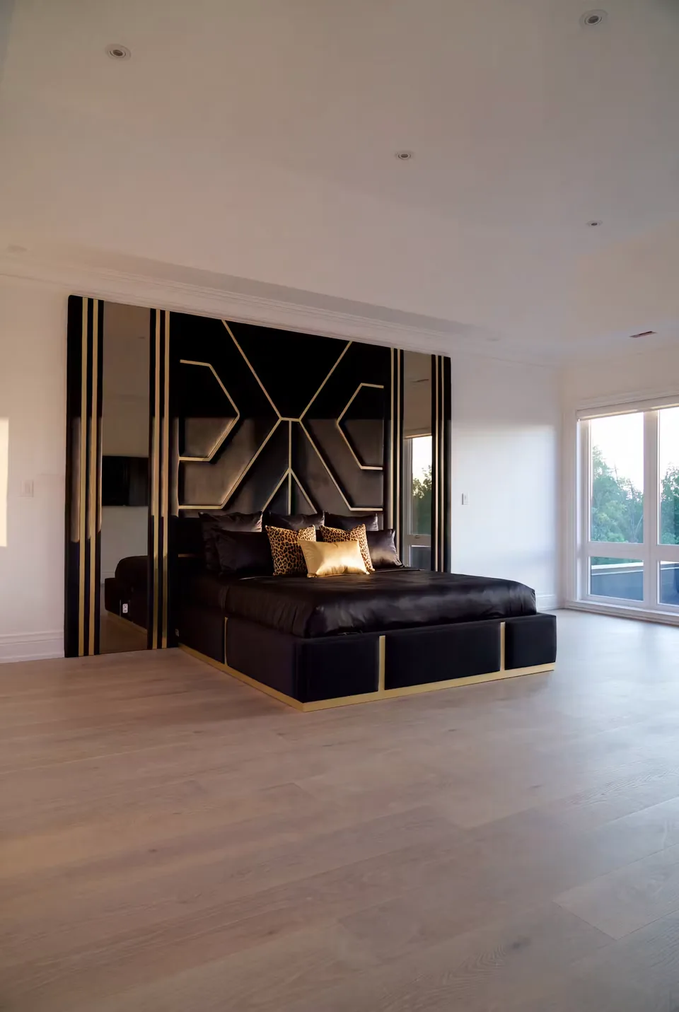 Wide bedroom view of the black and gold upholstered wall