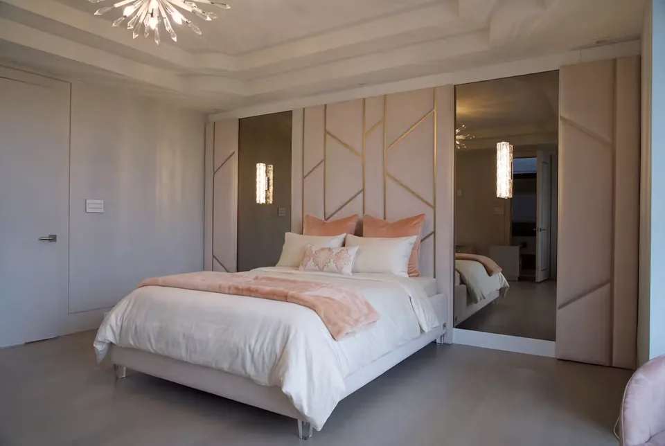 Full pale bed beneath blush branching panels flanked by mirrors