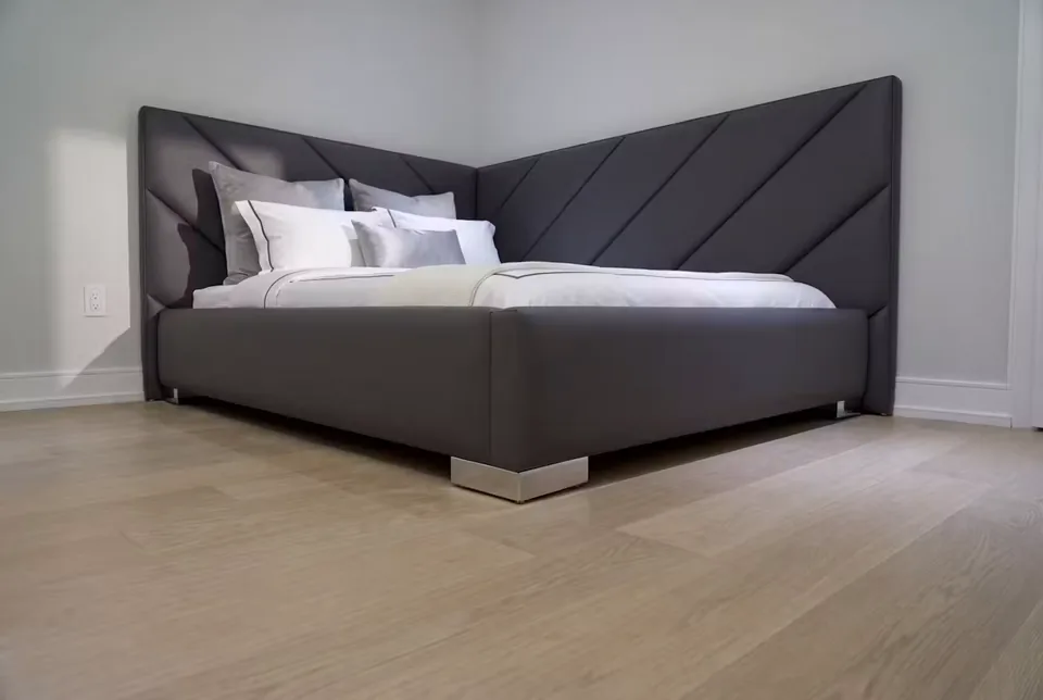 Full wide view of the dark bed and diagonal corner headboard