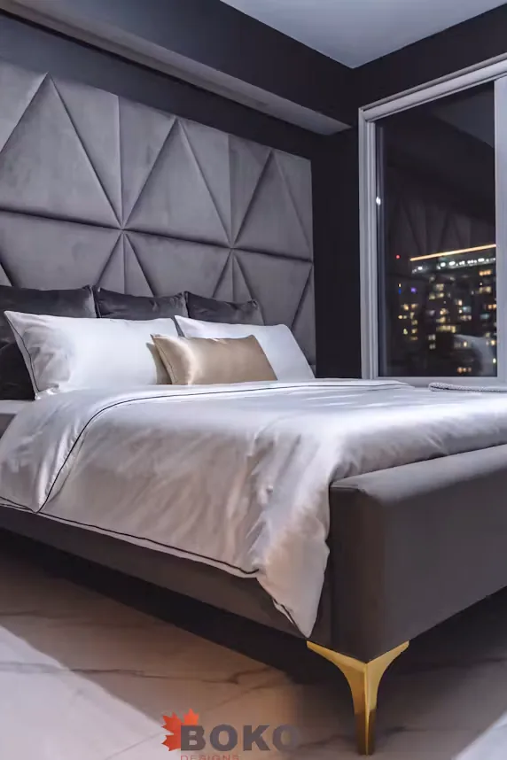 Portrait crop of the charcoal bed and triangular upholstered headboard wall