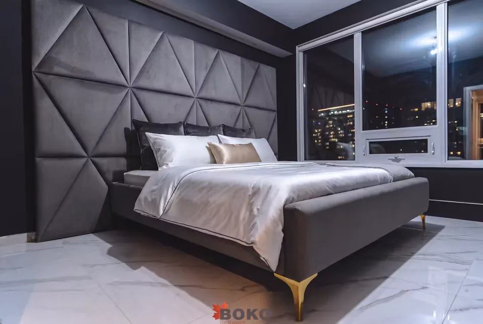 Full angled view of the charcoal bed and triangular upholstered wall