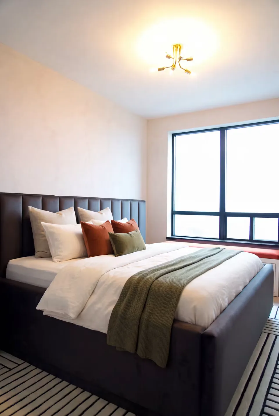 Full side view of the dark frame and wide channelled headboard