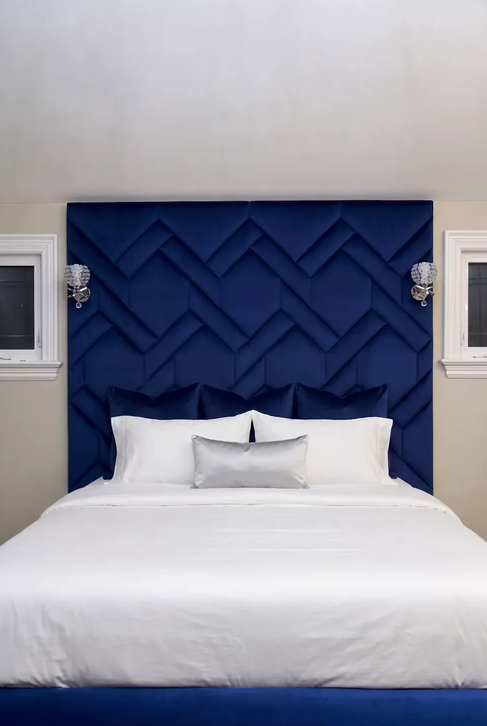 Front detail of the cobalt woven upholstery behind white pillows