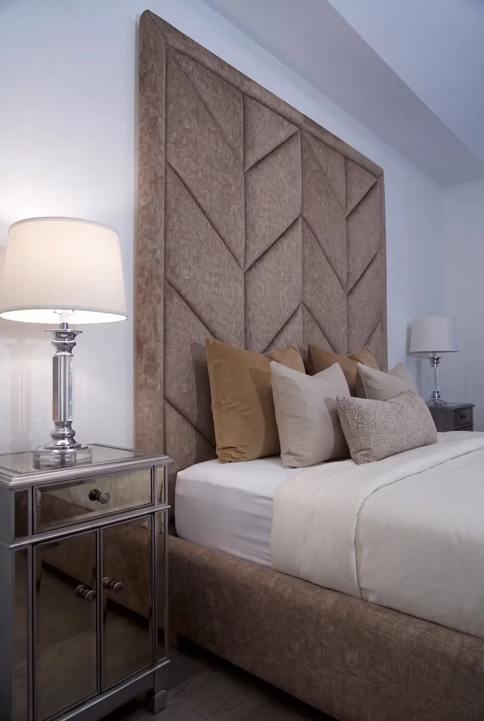 Side view of the cocoa headboard beside a bedside lamp
