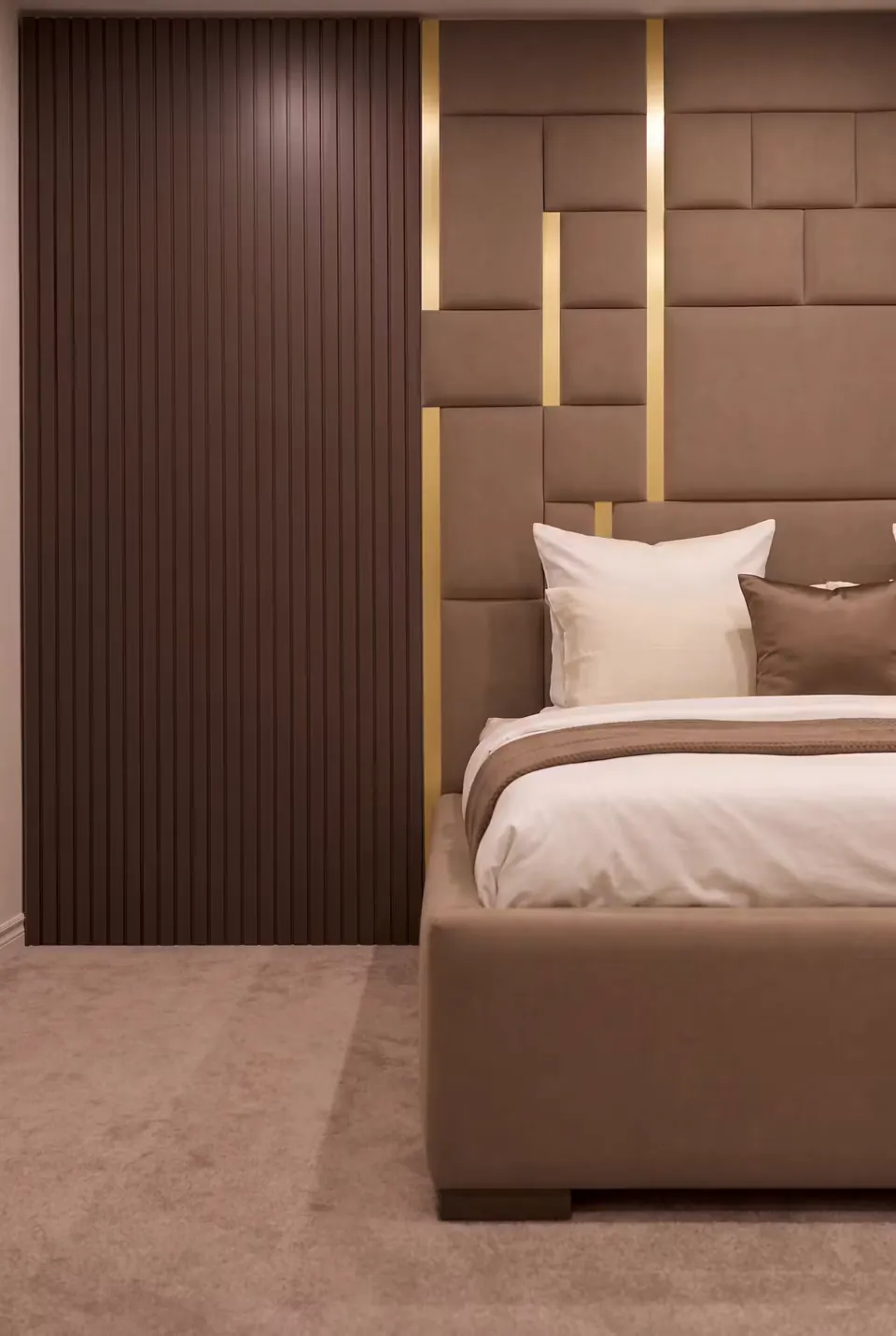 Side detail of the cocoa footboard and dark vertical slatted wall section.