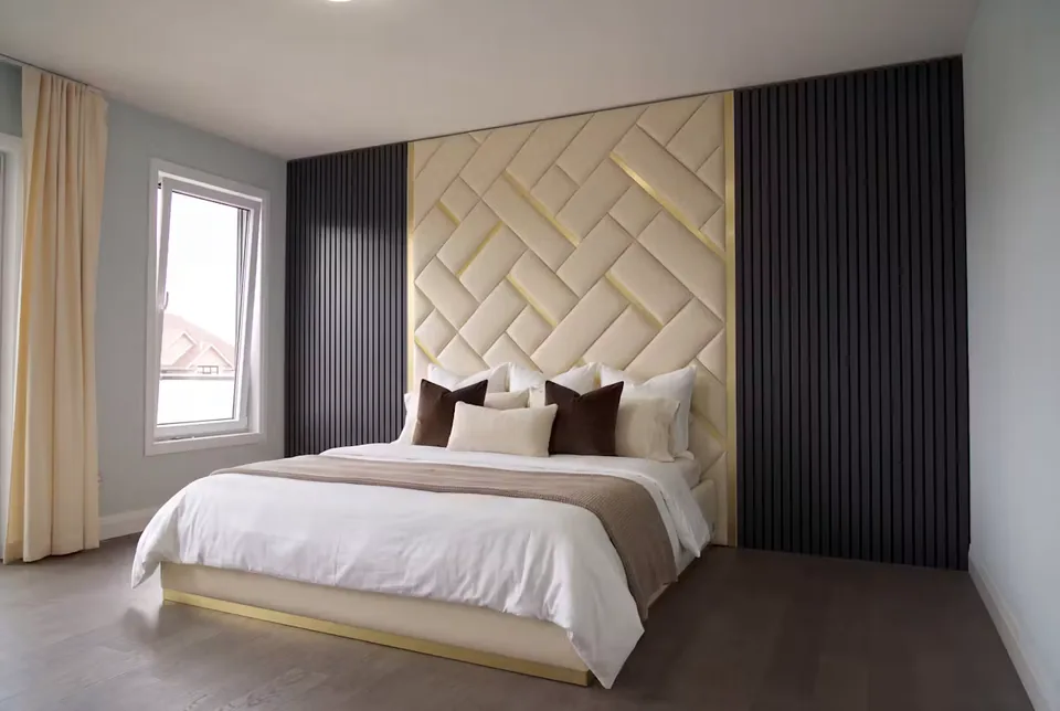 Full angled view of a cream bed beneath a tall woven upholstered wall and dark side panels.
