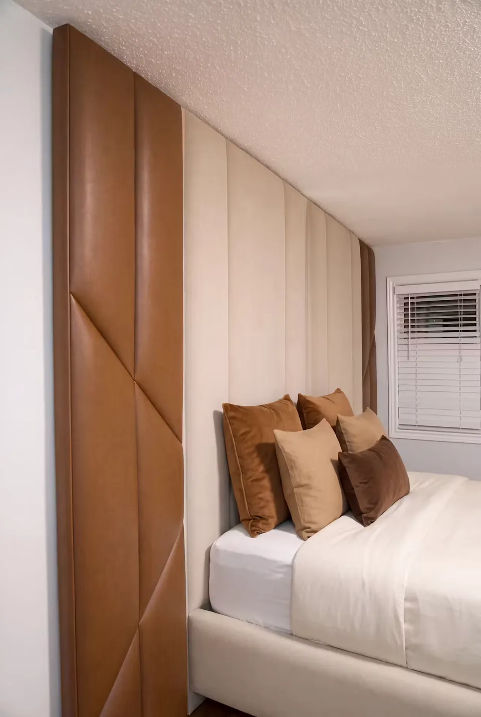 Close angle of the diagonal cocoa panels beside the cream headboard