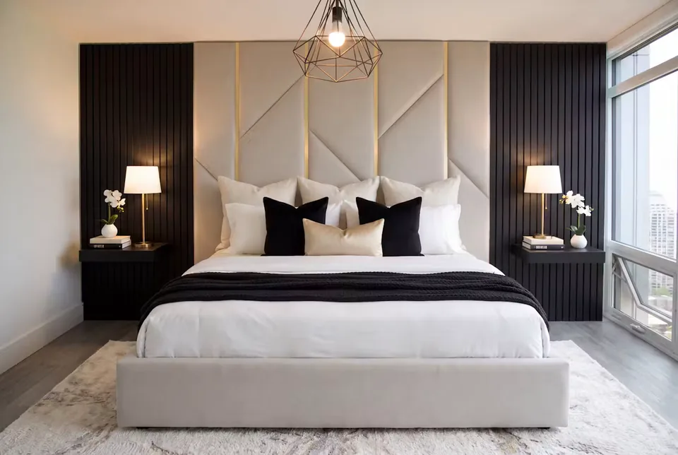 Pale upholstered bed below cream panels with gold-toned branches and dark slatted sides