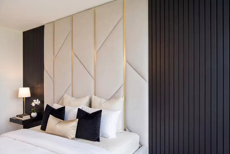 Angled view of the cream geometric headboard beside a wide bedroom window