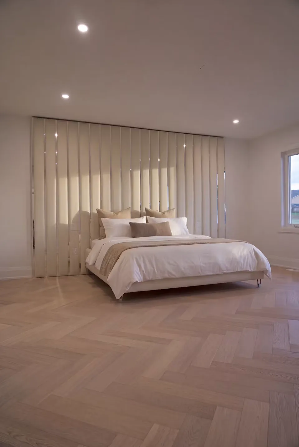 Angled view of the cream frame and full-height mirror-accented upholstery