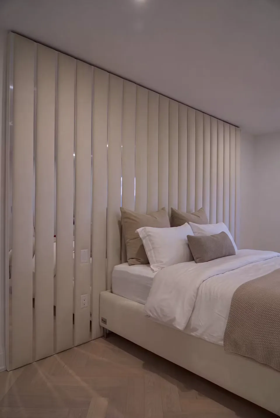 Side view of tall cream panels continuing behind the pillows
