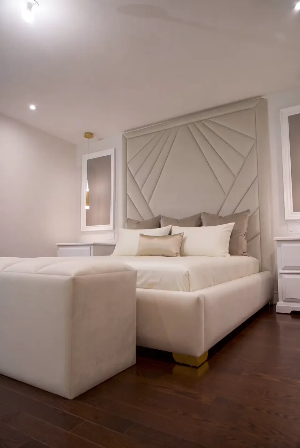 Front angled view of the cream bed beside the padded bench