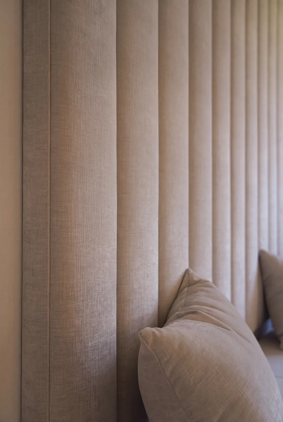 Close view of the textured greige vertical headboard channels.