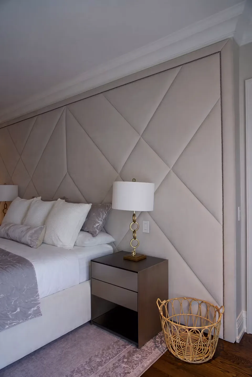 Detail of the crossing upholstery seams beside a bedside lamp