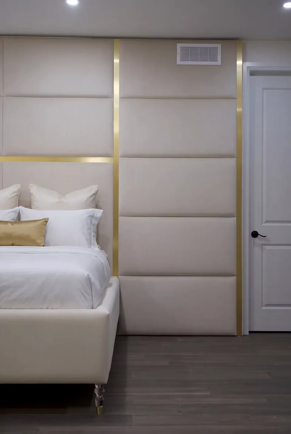 Detail of a gold crossbar separating broad padded panels