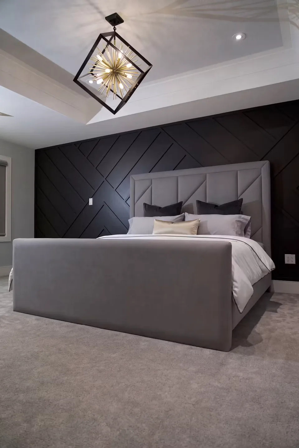 Full front view of the grey frame against the black diagonal wall