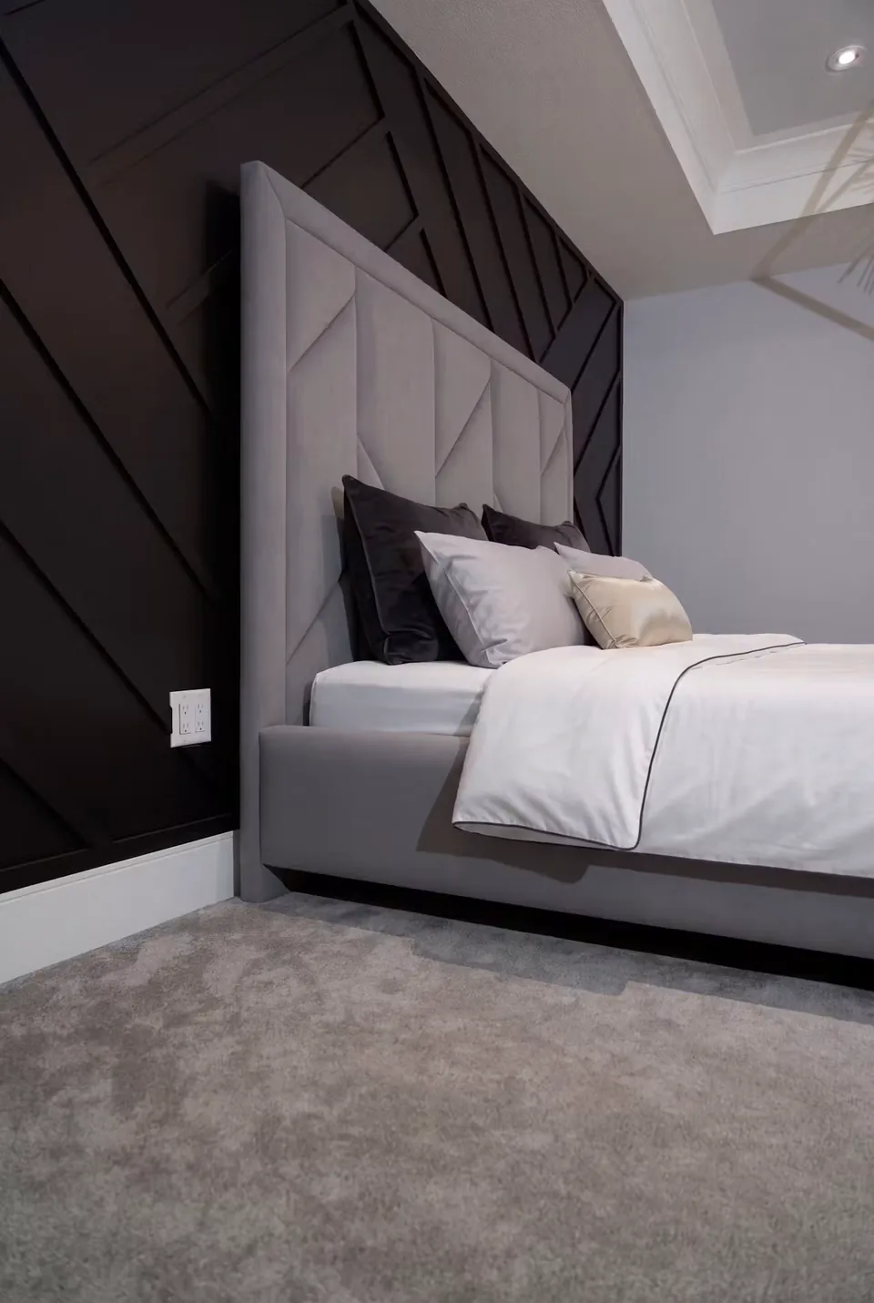 Side detail of the grey headboard beside the dark wall trim