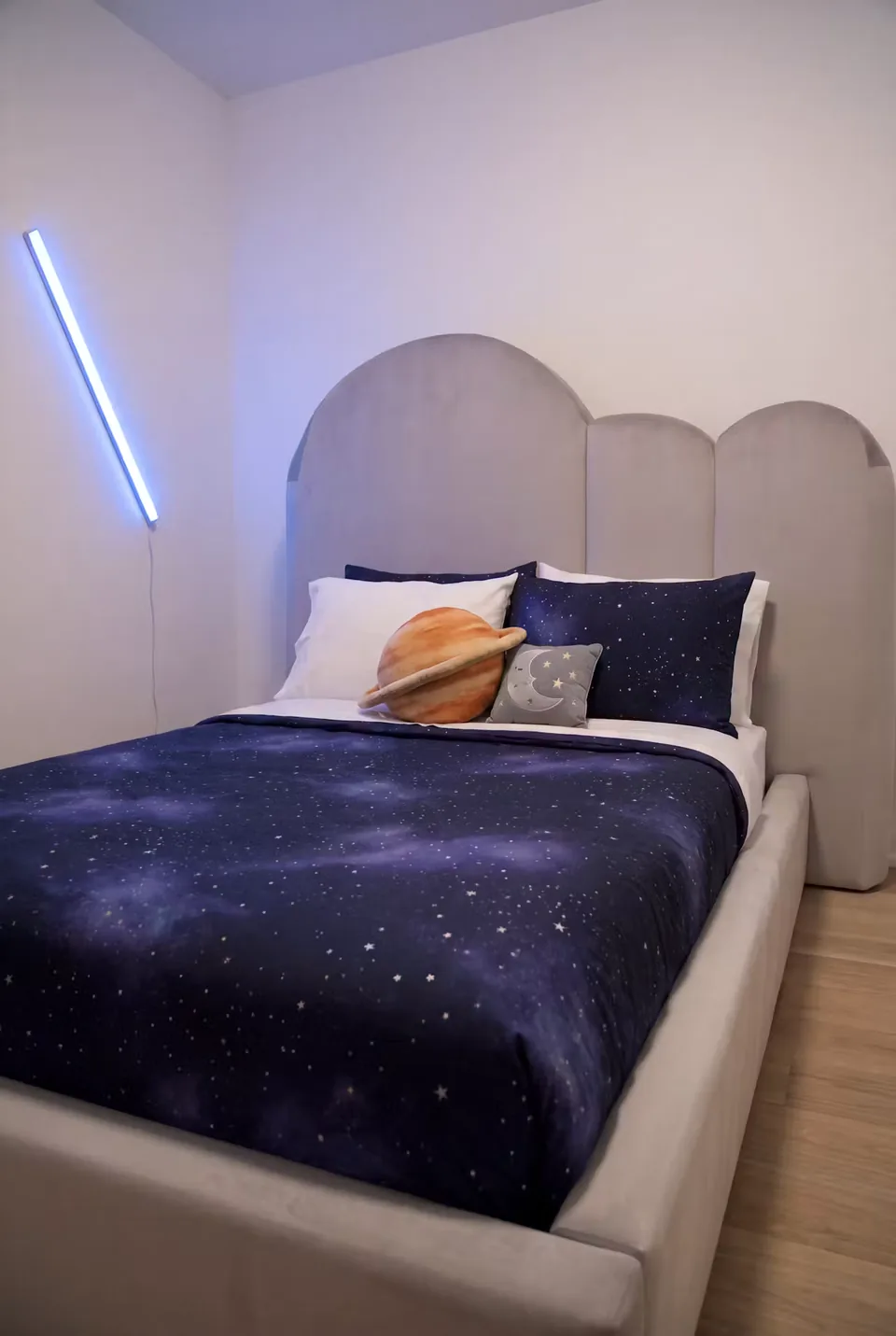 Front angled view of the pale bed beneath the rounded padded shapes