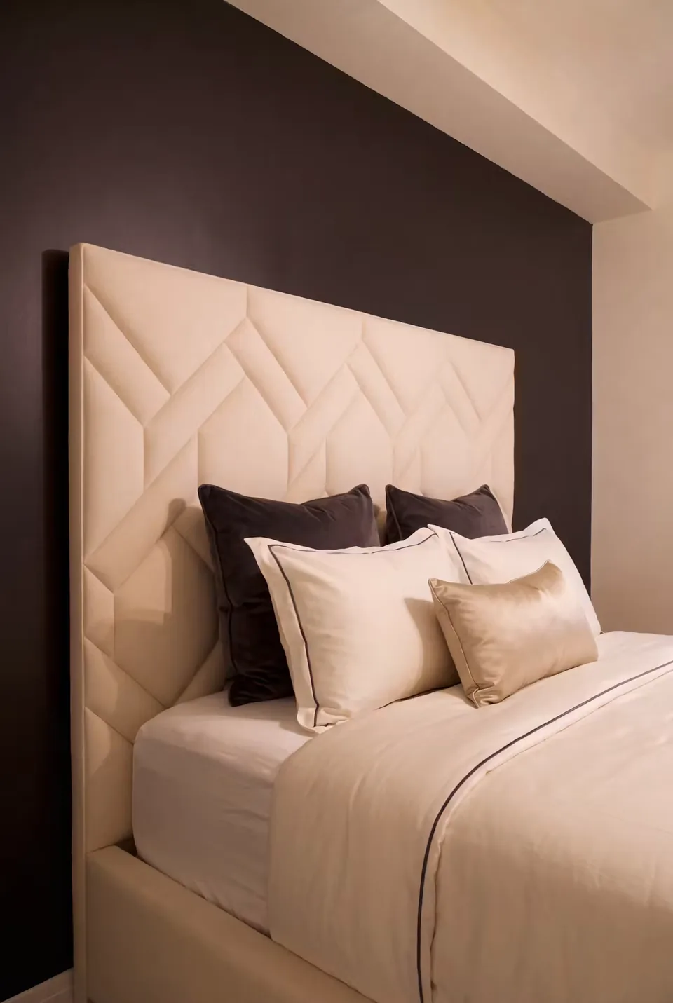 Angled view of the ivory headboard border and layered pillows