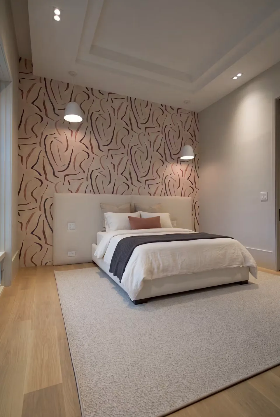 Angled view of the ivory frame with pendant lights beside the headboard