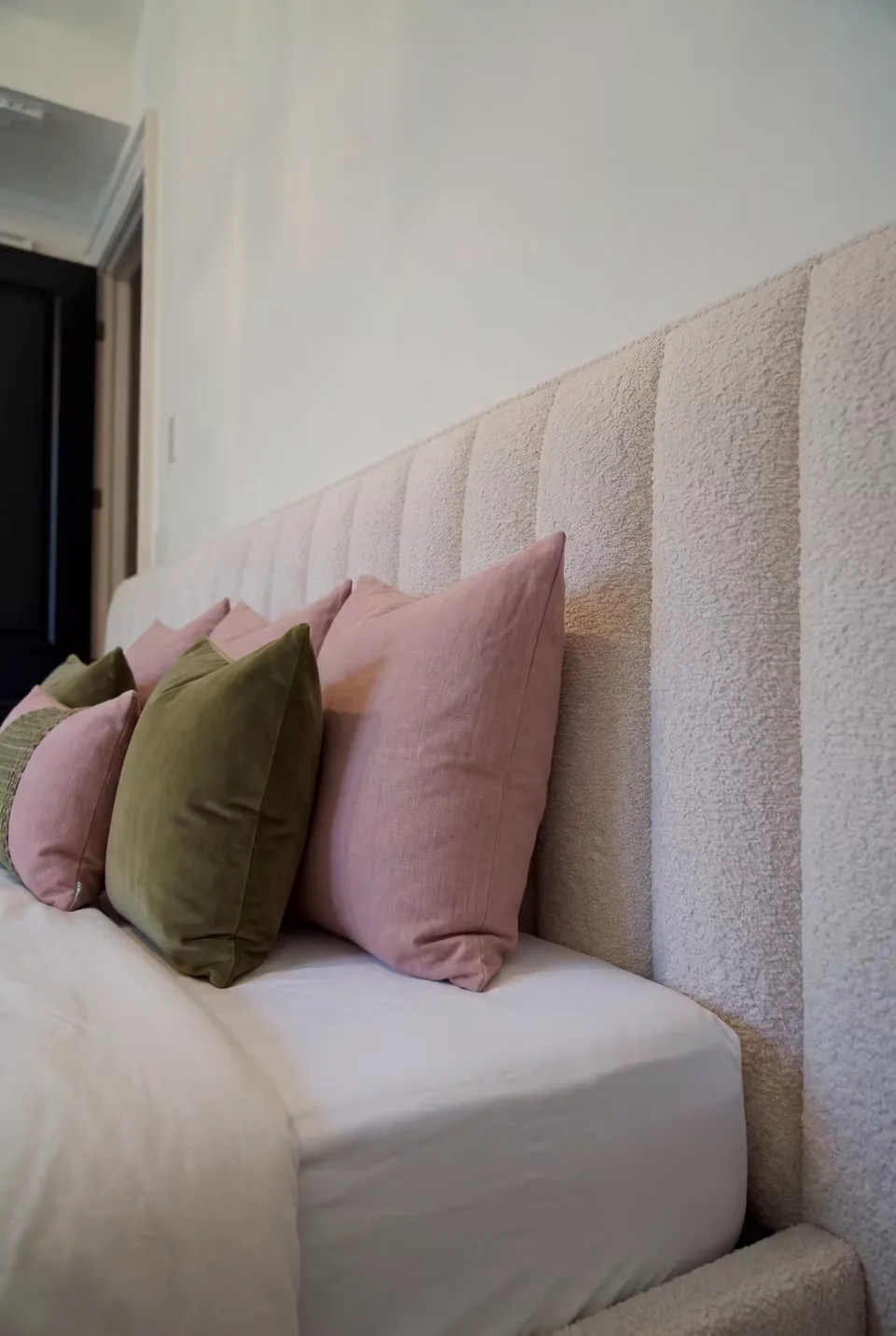 Close view of the ivory upholstered corner and frame