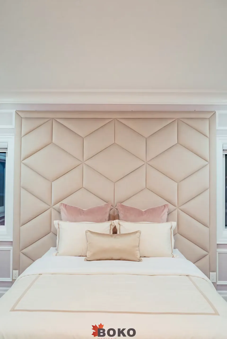 Closer view of the ivory diamond headboard and layered pillows