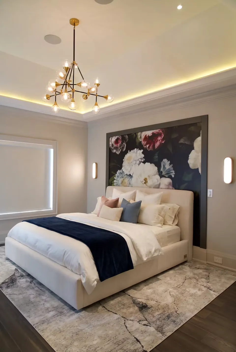 Full angled view of an ivory upholstered bed beneath a dark floral wall panel.