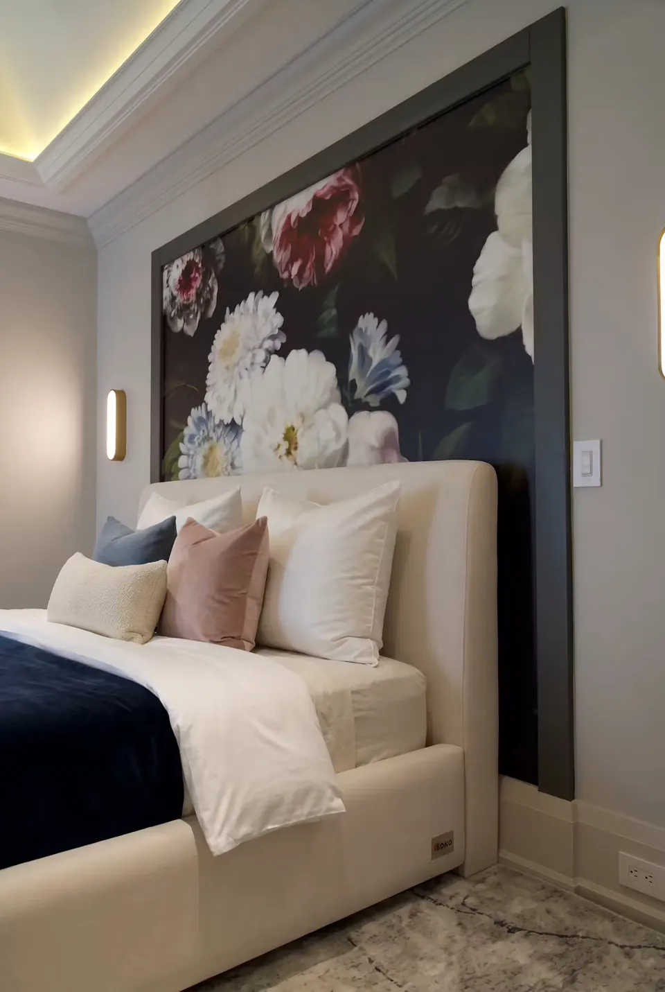 Close side view of ivory upholstery beneath the floral wall image.