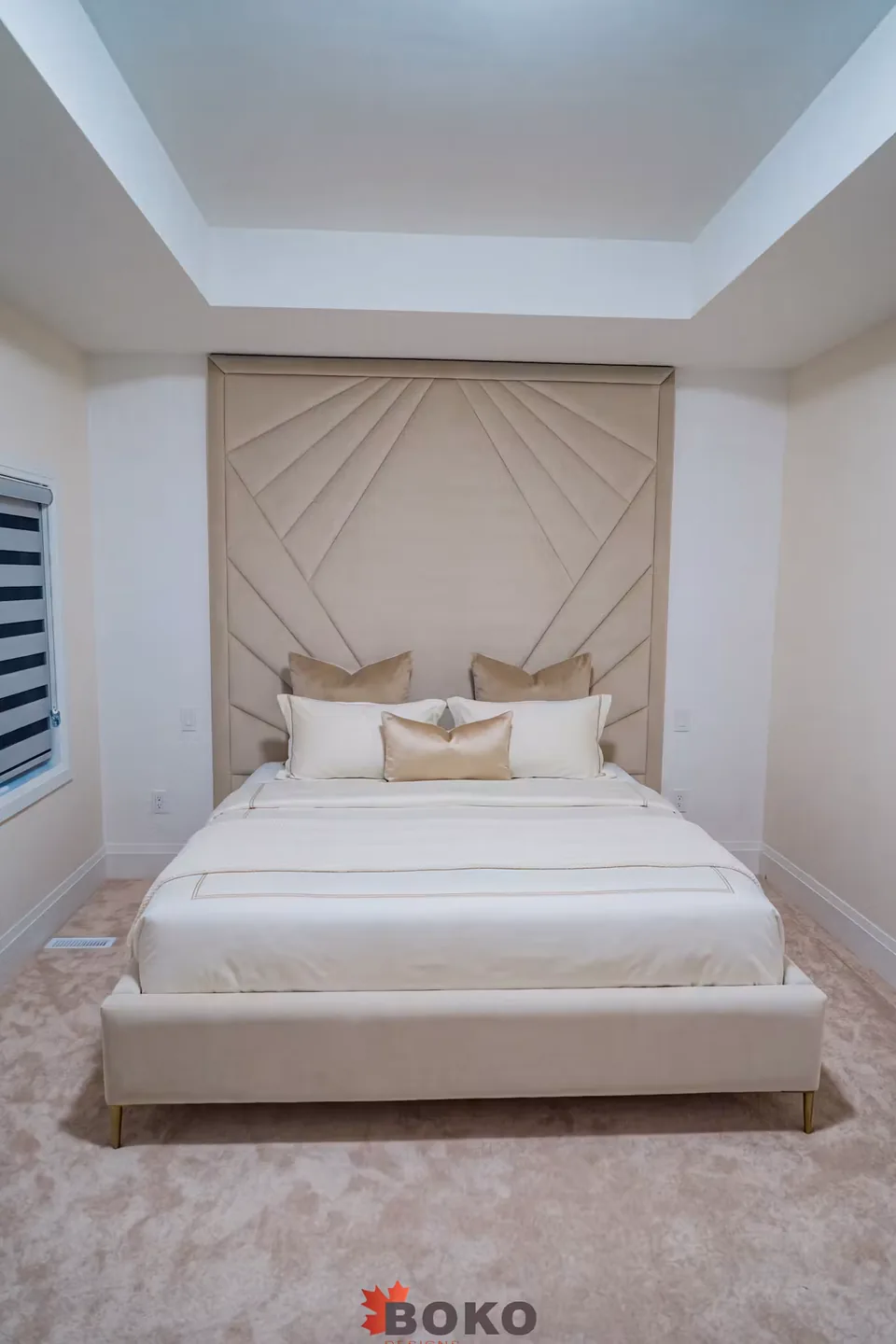 Full front view of the custom ivory bed and framed geometric headboard
