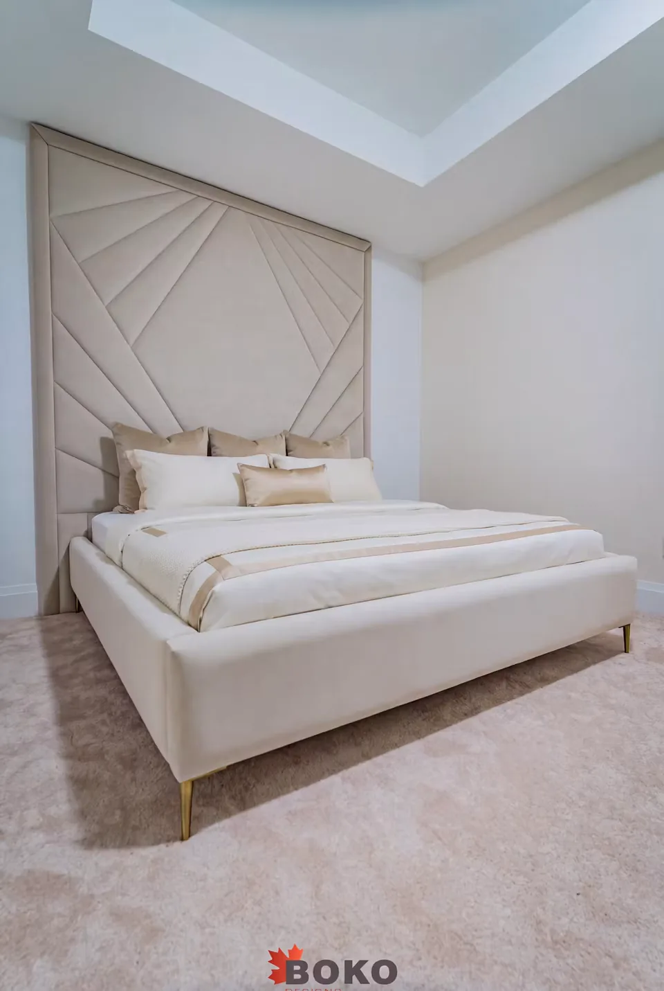 Angled view of the pale upholstered frame and radiating headboard