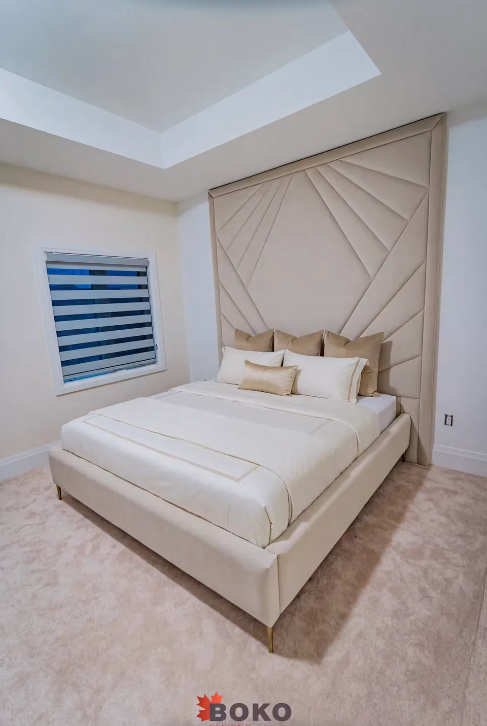 Side angle showing the ivory bed frame beside the window