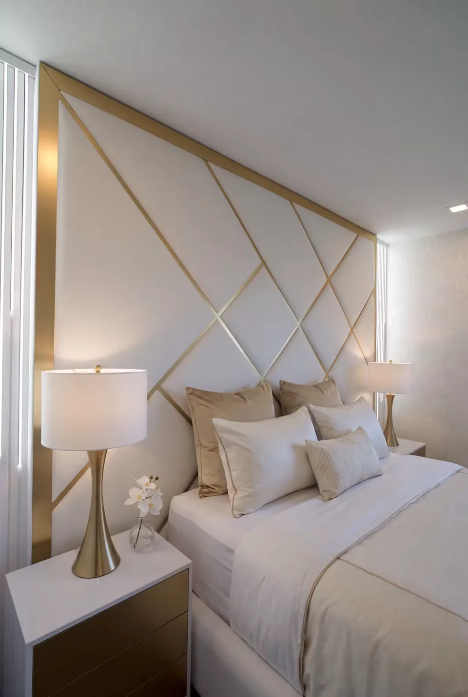 Side detail of the ivory padded wall and diagonal gold-toned strips