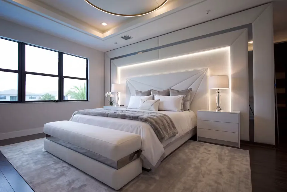 Wide room view of the ivory bed, bench and lit headboard border
