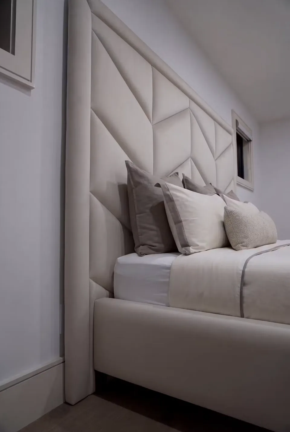 Close side view of the ivory chevron headboard and padded border