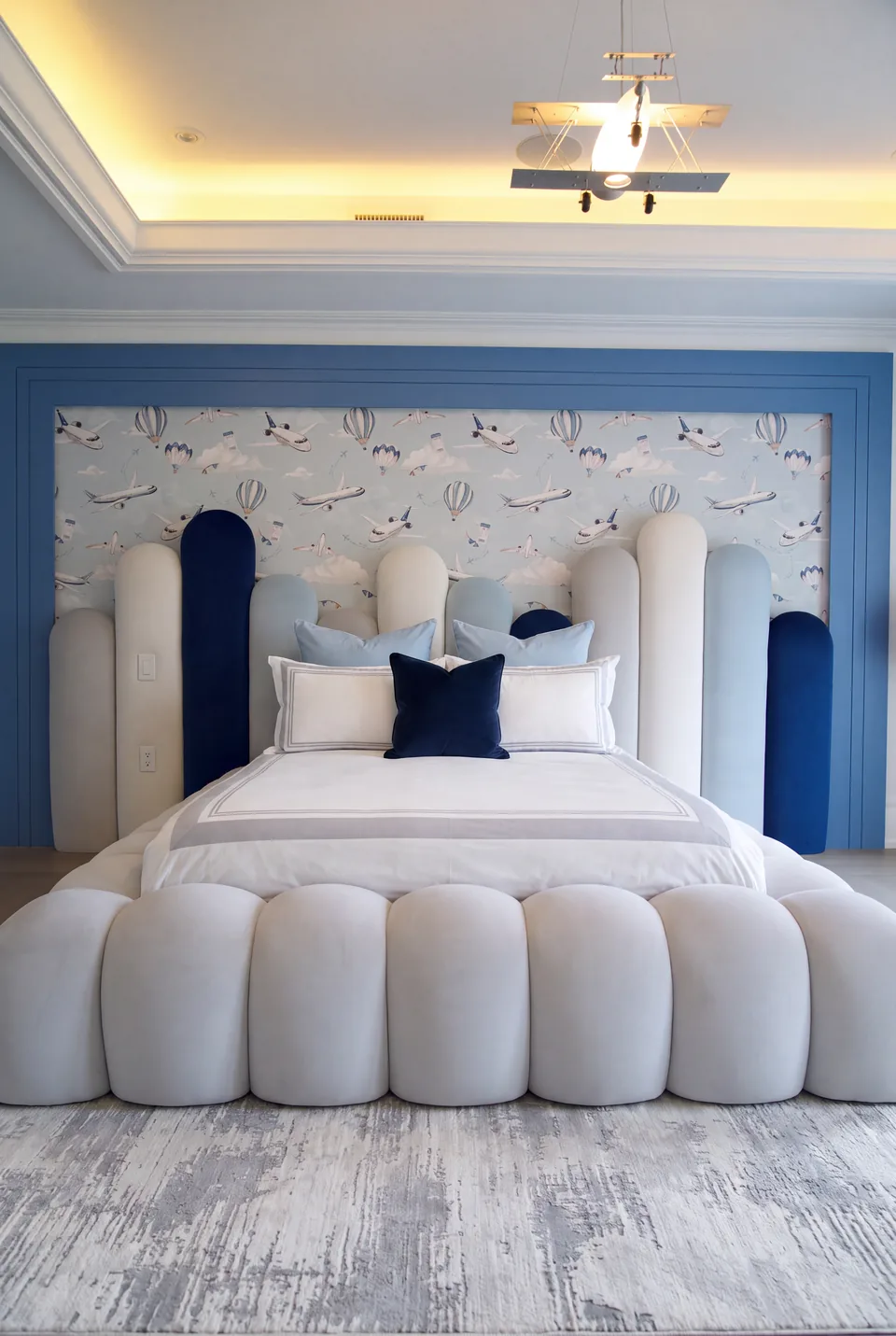Full front view of the sculptural ivory frame and curved headboard panels