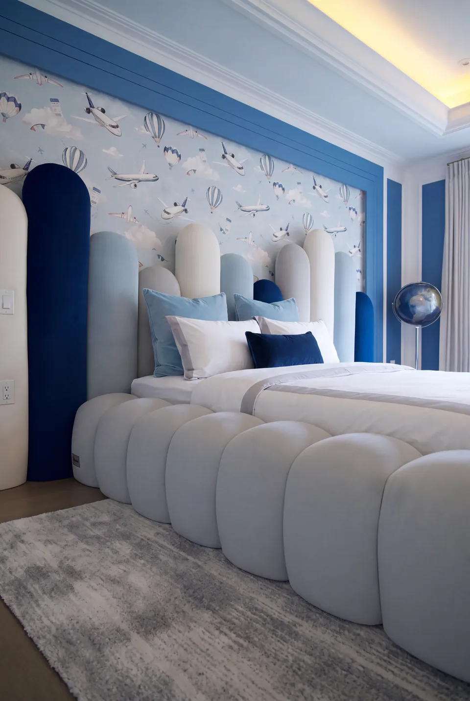 Detail of the tall ivory and blue padded headboard forms