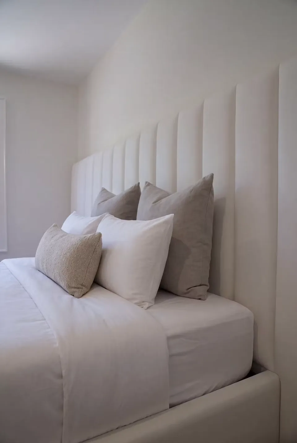 Close view of the rounded ivory frame and upholstered channels