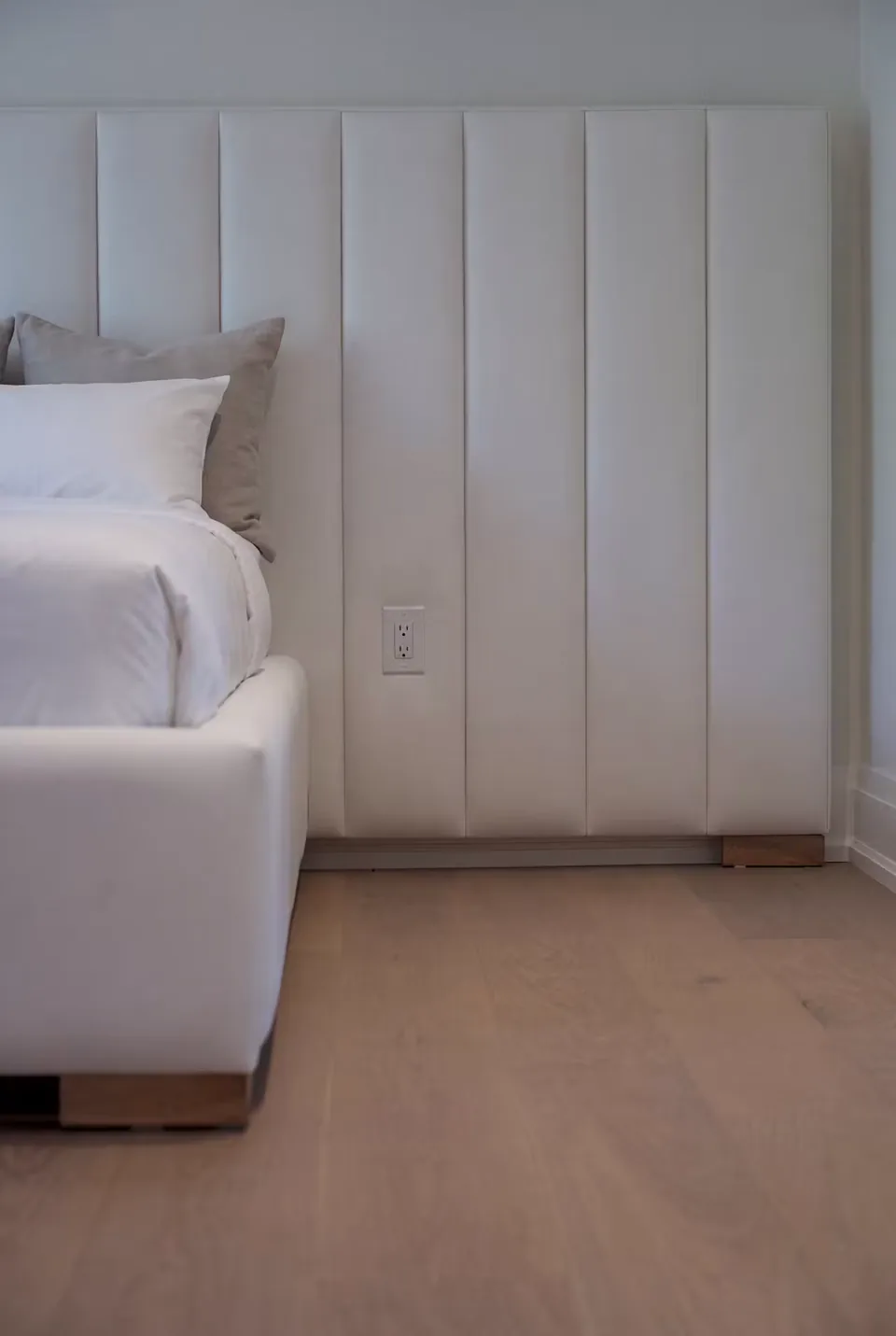 Detail of the broad vertical upholstery panels beside the bed