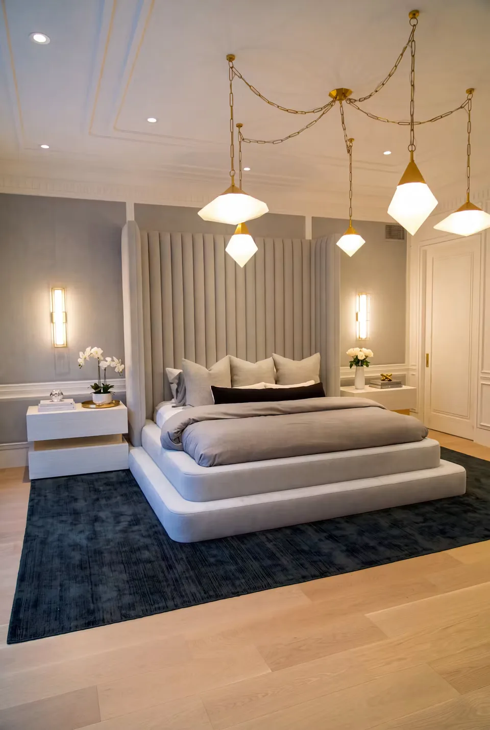 Custom upholstered bed with grey wall channels and a layered rounded platform base