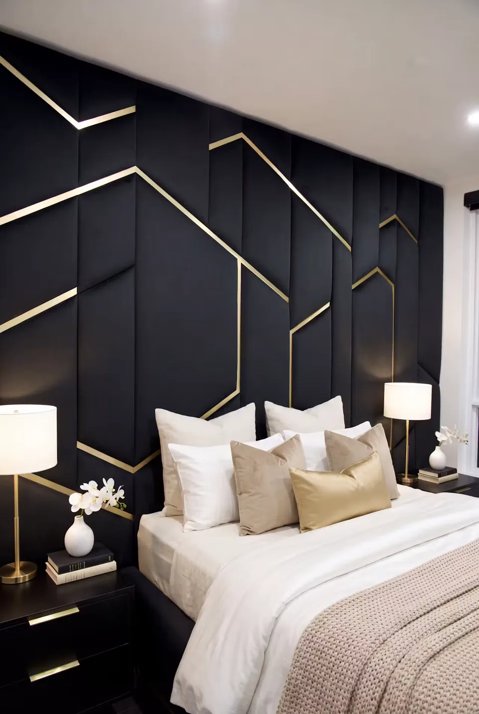Angled view of the dark bed and gold-toned branches across a padded backdrop