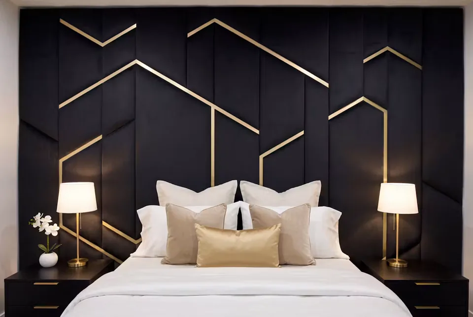 Front detail of dark upholstered wall panels and narrow gold-toned angles