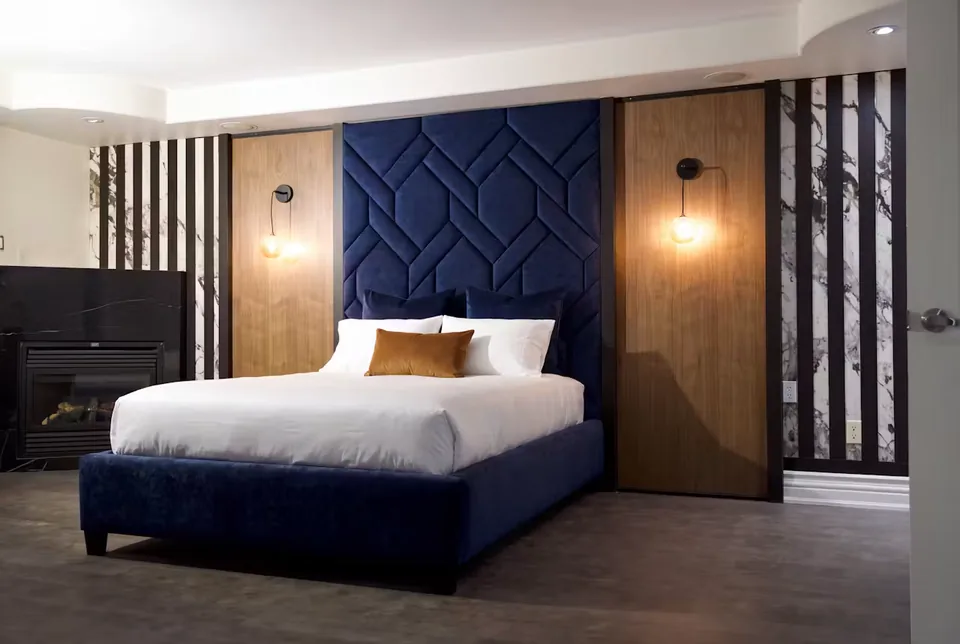 Full navy upholstered bed with woven geometric panels and slatted wall sides