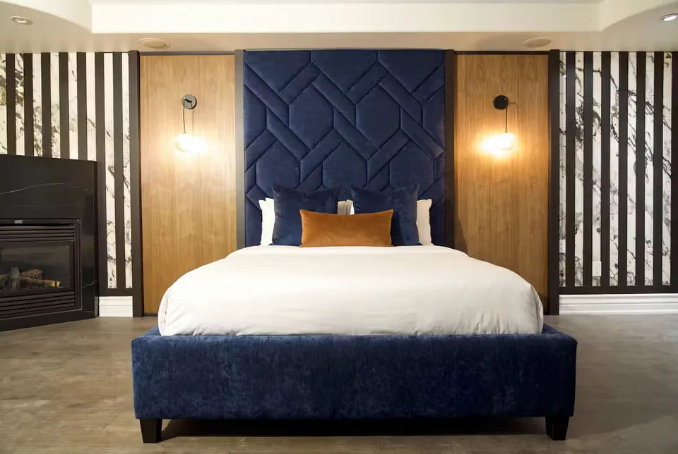 Front view of the navy frame and angular padded headboard