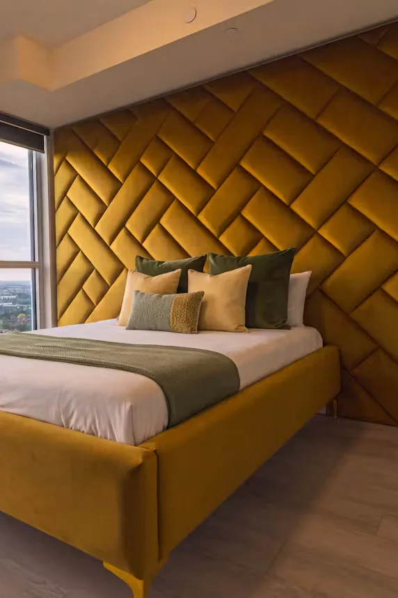 Portrait crop of the ochre bed and woven upholstered wall