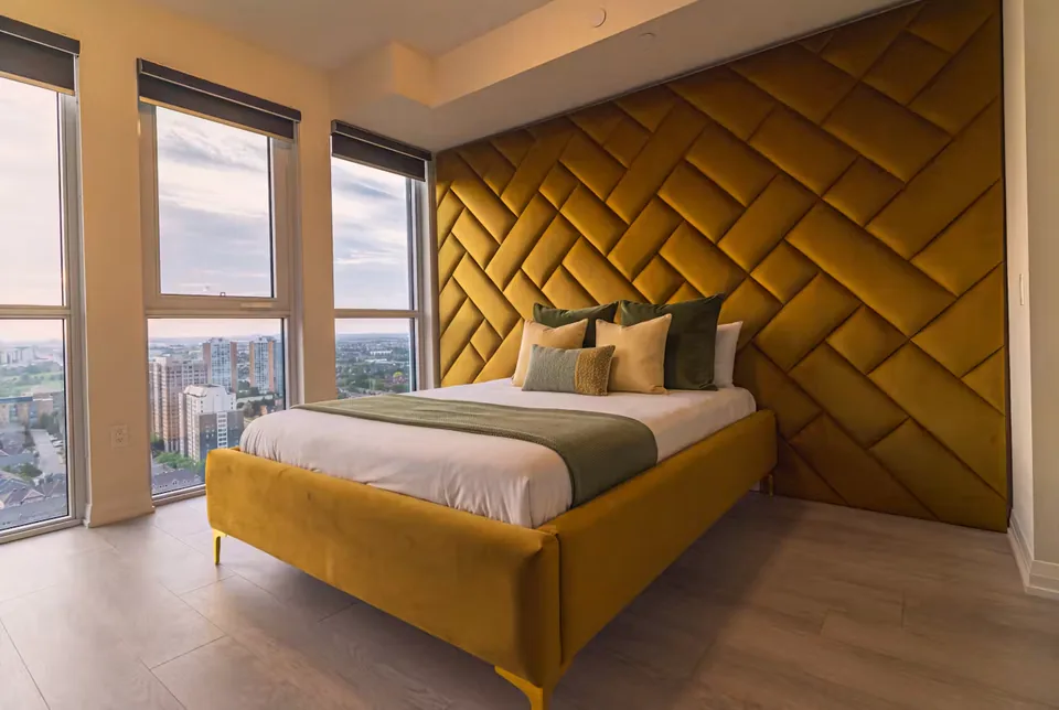 Full angled view of the ochre bed and woven upholstered wall