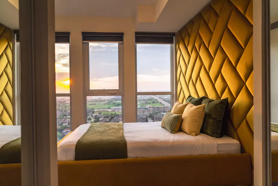 Side view of the golden yellow bed beneath the broad geometric backdrop