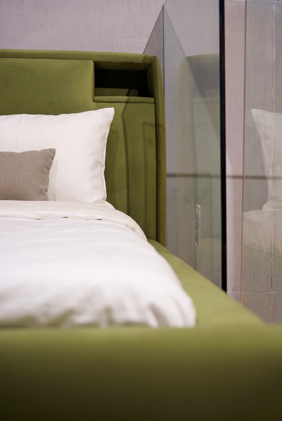Side detail of the olive headboard pocket and padded bed frame.