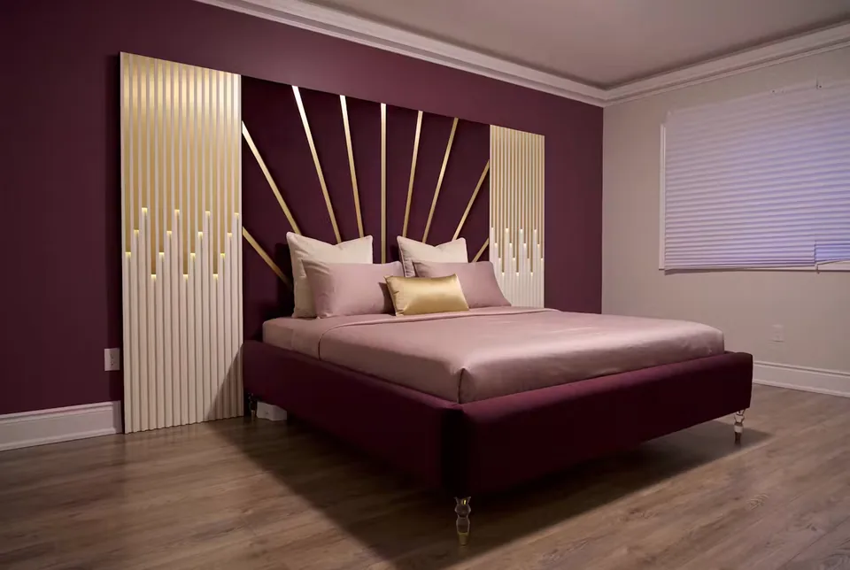 Full plum upholstered bed with gold rays and pale ribbed side panels