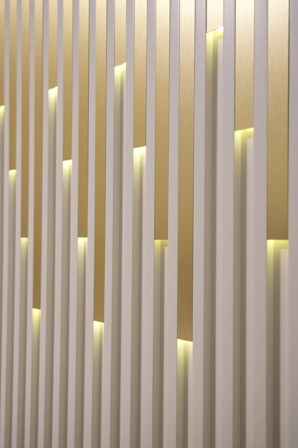 Detail of pale vertical side panels with gold accents