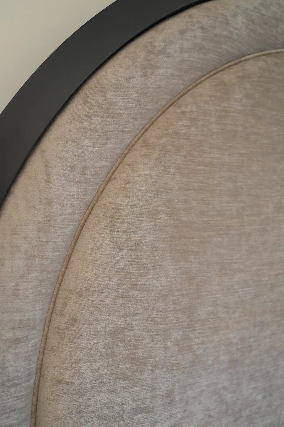 Close detail of textured grey upholstery inside the rounded black border.